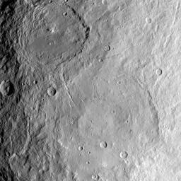 This image from NASA's Dawn spacecraft shows large craters Urvara (top) and Yalode (bottom) on dwarf planet Ceres. The two giant craters were formed at different times. Urvara is about 120-140 million years old and Yalode is almost 1 billion years older.