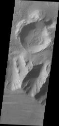 This view is located in eastern Coprates Chasma. The plateau above the chasma is visible in this image from NASA's 2001 Mars Odyssey spacecraft. The cliff face is very steep, with the elevation dropping over 3 miles from the plateau to the canyon floor.