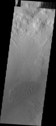 Moreux Crater is located in northern Arabia Terra. The crater contains a central peak, and dunes on the floor of the crater. This image from NASA's 2001 Mars Odyssey spacecraft shows the dune field to the northwest of the central peak.