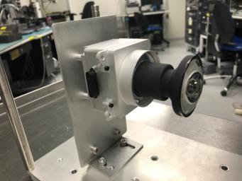 This image shows one of the enhanced engineering cameras with a prototype lens for the Hazcams, which will watch for obstacles encountered by NASA's Mars 2020 rover.