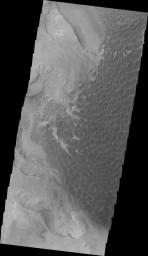 This image from NASA's 2001 Mars Odyssey spacecraft shows Rabe Crater. The appearance of the exposed side of the cliffs does not look like a volcanic, difficult to erode material, but rather an easy to erode material such as layered sediments.