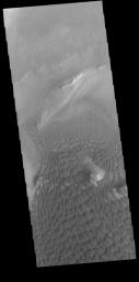 This image captured by NASA's 2001 Mars Odyssey spacecraft provides another instance where the topography of the upper floor material affects the winds and dune formation.