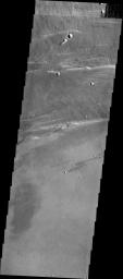 This image captured by NASA's 2001 Mars Odyssey spacecraft shows part of the northwestern margin of the summit caldera. This image illustrates the many processes that occurred in the formation of the volcano.