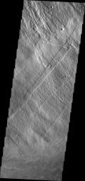 This image from NASA's 2001 Mars Odyssey spacecraft shows part of the southeastern flank of Arsia Mons, including the flat lying flows around the base of the volcano. These flows are located at the bottom of the image.