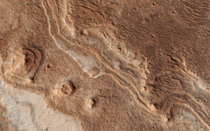 Layers, probably sedimentary in origin, have undergone extensive erosion in this image from NASA's Mars Reconnaissance Orbiter (MRO) of Shalbatana Valles, a prominent channel that cuts through Xanthe Terra.