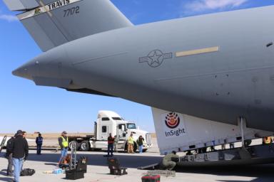 Personnel supporting NASA's InSight mission to Mars load the crated InSight spacecraft into a C-17 cargo aircraft at Buckley Air Force Base, Denver, for shipment to Vandenberg Air Force Base, California.
