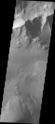 This image from NASA's 2001 Mars Odyssey spacecraft shows part of Tithonium Chasma. A lobate 'tongue' visible between the ridge and the top of the canyon is the deposit left by a landslide event.