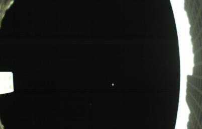 The is the first image captured by one of NASA's Mars Cube One (MarCO) CubeSats showing both the CubeSat's unfolded high-gain antenna at right and the Earth and its moon in the center, acquired by MarCO-B on May 9, 2018.