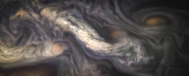 This image captures a high-altitude cloud formation surrounded by swirling patterns in the atmosphere of Jupiter's North North Temperate Belt region as seen by NASA's Juno spacecraft.