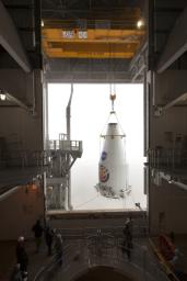 The payload fairing of the Atlas V rocket that would launch NASA's InSight lander to Mars is lifted up so that it can be mated to the top of the rocket.
