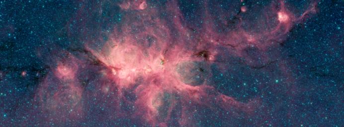 The Cat's Paw Nebula, imaged here by NASA's Spitzer Space Telescope, shows a dark filament running through the middle, composed of dense gas and dust.