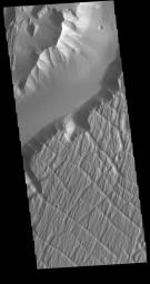 This image from NASA's Mars Odyssey shows the relative high land of Lunae Planum. The Kasei Valles channel is just below. Also shown is an eroded surface that forms an island in the channel. The surface of the island has been modified by the flow of water