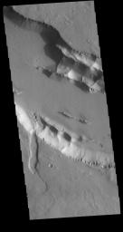 This image from NASA's Mars Odyssey shows part of one of the Elysium Fossae on the western flank of the Elysium volcanic complex. The fossae have both a tectonic and volcanic origin.