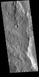 This image from NASA's Mars Odyssey shows a ridge, located in Terra Sabaea, which contains dark slope streaks. These features are thought to form by downslope movement of material.