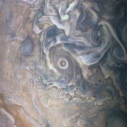 Intricate swirls in Jupiter's volatile northern hemisphere are captured in this image from NASA's Juno spacecraft. Bursts of scattered bright-white 'pop-up' clouds appear with some visibly casting shadows on the neighboring cloud layers beneath them.