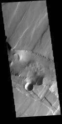 This image from NASA's Mars Odyssey shows Noctis Labyrinthus. There are two directions of faults visible, which intersect at an approximately 90 degree angle.