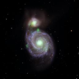 Sources of high-energy X-ray light captured by NASA's NuSTAR mission are overlaid on an image of the Whirlpool galaxy and its companion galaxy, M51b, taken by the Sloan Digital Sky Survey.