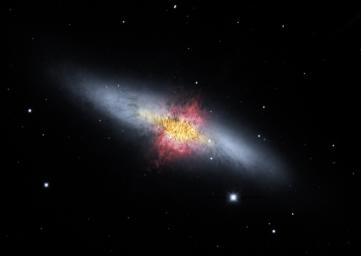 The magnetic field lines of the the Cigar Galaxy (also called M82) appear in this composite image produced by NASA's Spitzer Space Telescope. The lines follow the bipolar outflows (red) generated by exceptionally high rates of star formation.