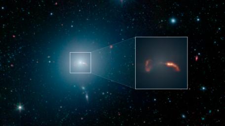 The galaxy M87, imaged here by NASA's Spitzer Space Telescope, is home to a supermassive black hole that spews two jets of material out into space at nearly the speed of light.