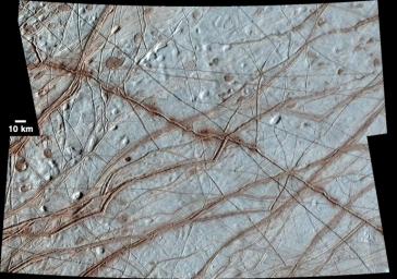 This image from NASA's Galileo Solid-State Imager (SSI) shows Europa's surface is covered with a vast network of linear features such as cracks, ridges, and bands.