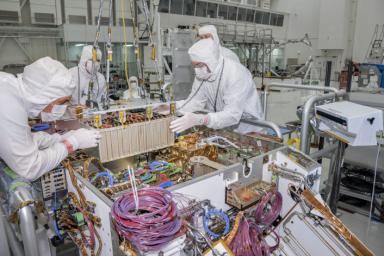 Engineers and technicians at NASA's Jet Propulsion Laboratory in Pasadena, California, integrate the rover motor controller assembly (RMCA) into the Mars 2020 rover's body.