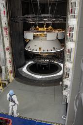 An engineer inspects the completed spacecraft that will carry NASA's next Mars rover to the Red Planet, prior to a test in the Space Simulator Facility at NASA's Jet Propulsion Laboratory in Pasadena, California.