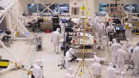 A team of engineers at NASA's Jet Propulsion Laboratory in Pasadena, California, install the legs and wheels on the Mars 2020 rover.