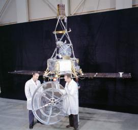 This image shows two engineers standing with Mariner 1 on May 2, 1962, at JPL's Spacecraft Assembly Facility.