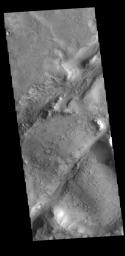 This image from NASA's Mars Odyssey shows two linear depressions which are part of the Nili Fossae fracture system.