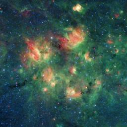 This infrared image from NASA's Spitzer Space Telescope shows a cloud of gas and dust full of bubbles, which are inflated by wind and radiation from massive young stars.