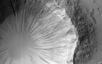 This image, acquired on July 21, 2019 by NASA's Mars Reconnaissance Orbiter, shows steep walls of a crater, covered with slope streaks, formed by material falling down towards the crater's center.