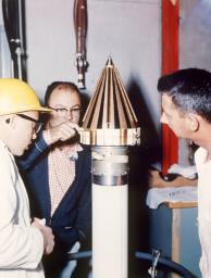 This image from March 2, 1959 shows engineers from NASA's Jet Propulsion Laboratory checking NASA's Pioneer 4 spacecraft.