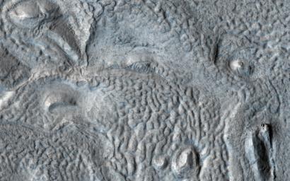 This image acquired on July 21, 2019 by NASA's Mars Reconnaissance Orbiter, shows the mid-latitudes of Mars, draped with deposits of water ice and dust on the order of tens of meters thick.