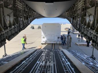 The shipping container carrying NASA's Mars 2020 rover is readied for loading aboard an Air Force C-17 transport plane at March Air Reserve Base in Riverside, California, on Feb. 11, 2020.