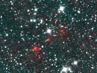 Comet C/2020 F3 NEOWISE appears as a string of fuzzy red dots in this composite of several heat-sensitive infrared images taken by NASA's NEOWISE mission on March 27, 2020.