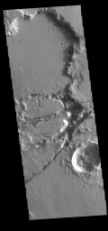 This image from NASA's Mars Odyssey shows linear depressions, part of Sirenum Fossae. These depressions are called graben, which form by the down drop of material between two parallel faults.