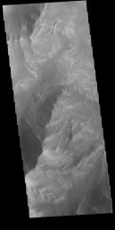 This image from NASA's Mars Odyssey shows part of the southern cliffside of Melas Chasma. Melas Chasma is part of the largest canyon system on Mars, Valles Marineris.