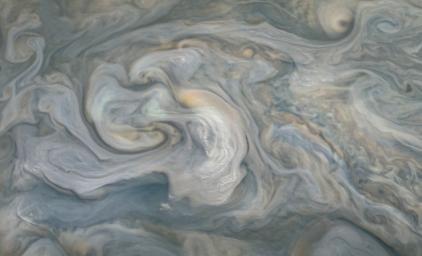 In the center of this JunoCam image, small, bright pop-up clouds seen rise above the surrounding features. Clouds like these are thought to be the tops of violent thunderstorms responsible for shallow lighting.