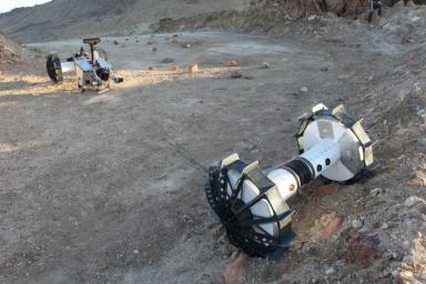 During the same field test, the DuAxel rover separates into two single-axled robots so that one can rappel down a slope too steep for conventional rovers.