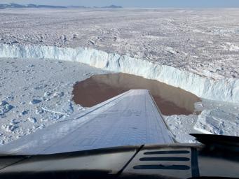 To measure water depth and salinity, the OMG project dropped probes by plane into fjords along Greenland's coast. Shown here is one such fjord in which a glacier is undercut by warming water.
