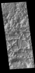 This image from NASA's Mars Odyssey shows a region, south of Eos Chasma, where the mesas have eroded down into small hills, as well as large, steep sided mesas.