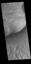 This image from NASA's Mars Odyssey shows part of the floor of Becquerel Crater, including a large layered deposit. Becquerel Crater is located in Arabia Terra and is 165km (102 miles) in diameter.