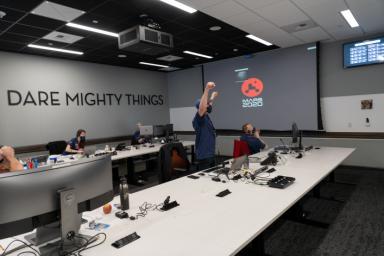 Members of NASA's Mars 2020 Perseverance rover mission celebrate on Feb. 18, 2021, after learning the spacecraft has touched down on Mars. They are in the Entry, Descent and Landing War Room at NASA's Jet Propulsion Laboratory in Southern California.