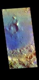 This image from NASA's Mars Odyssey shows a crater in Arabia Terra. Dark blue in this filter combination indicates basaltic sand.