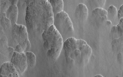 This image acquired on August 17, 2020 by NASA's Mars Reconnaissance Orbiter, shows Martian scallops. As the ice ablates away in some spots the surface dust collapses into the hole that's left.
