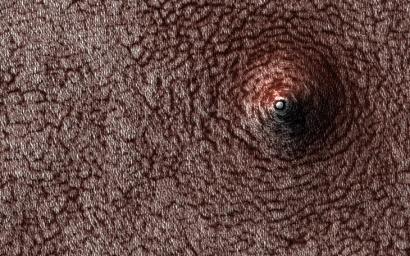 This image acquired on December 28, 2020 by NASA's Mars Reconnaissance Orbiter, shows a pit that has formed on the south polar layered deposits.
