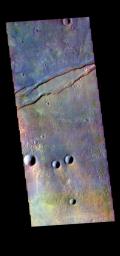 This image from NASA's Mars Odyssey shows part of Sirenum Fossae. The linear depressions at the top of the image are called graben.