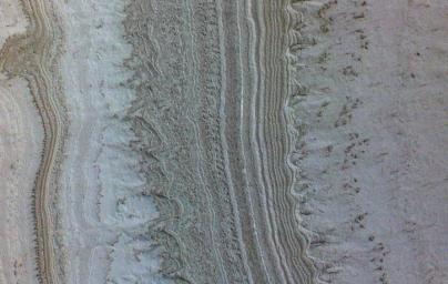 This image taken by NASA's Mars Reconnaissance Orbiter shows ice sheets at Mars' south pole. The spacecraft detected clays nearby this ice; previously interpreted as liquid water.