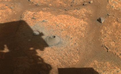 This image taken by one of the hazard cameras aboard NASA's Perseverance rover on August 6, 2021, shows the hole drilled in what the rover's science team calls a paver rock in preparation for the mission's first attempt to collect a sample from Mars.