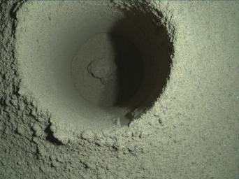This composite image of Perseverance's first borehole on Mars was generated using multiple images taken by the rover's WATSON imager.